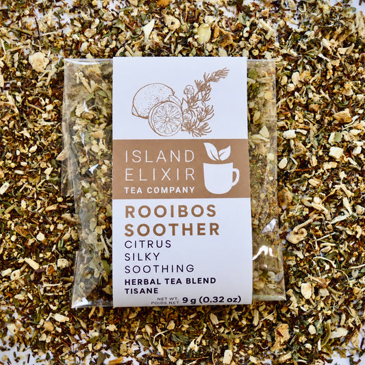 Rooibos Soother Herbal Tea 4 cups of tea size compostable packaging sitting on loose leaf tea that contains Marshmallow root, lemon, rooibos, elderflower, peppermint