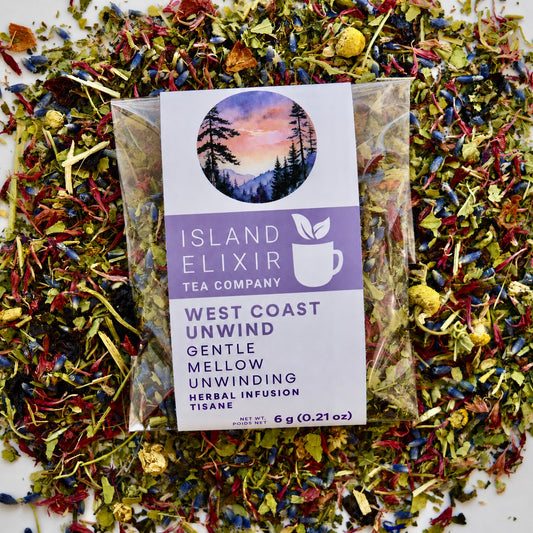 West Coast Unwind Herbal Tea 4 cups of tea size compostable packaging sitting on loose leaf tea that contains rose hip, lemon balm, lavender, marshmallow leaf, passion flower chamomile, red cornflower.