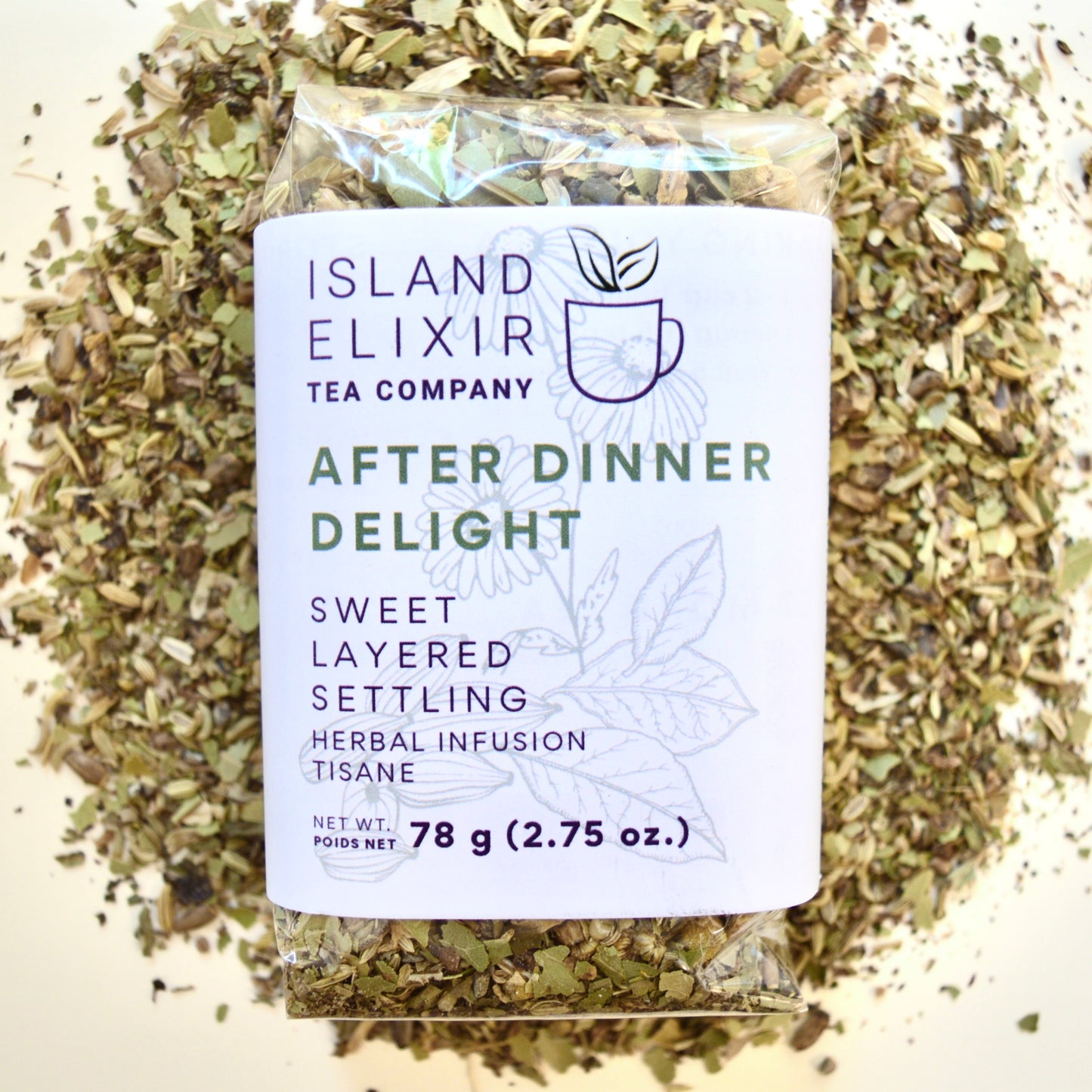 After Dinner Delight Herbal Tea 30 cups of tea size compostable packaging sitting on loose leaf tea that contains Fennel seed*, milk thistle seed*, green cardamom*, bay leaf*, lemon*, lemon balm*, peppermint*, chamomile*.