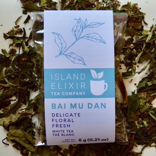 Bai Mu Dan White Tea 10 cups of tea size compostable packaging sitting on loose leaf tea that contains Chinese White Tea
