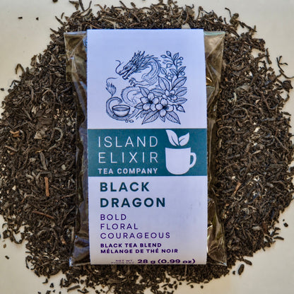 Black Dragon Black Tea 10 cups of tea size compostable packaging sitting on loose leaf tea that contains black tea with jasmine scented green tea