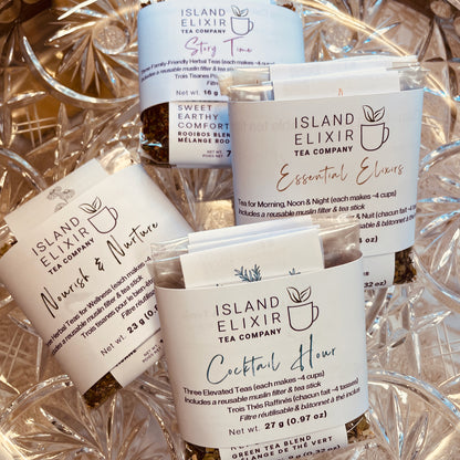 Four tea trios - Nourish and Nurture, Essential Elixirs, Story Time, Cocktail Hour - displayed on a glass plate. Each trio is shown in the Discover size, with each tea making approximately 4 cups. Each trio includes one reusable muslin tea filter and tea stick for easy loose leaf tea steeping. Home compostable packaging and recyclable labels.