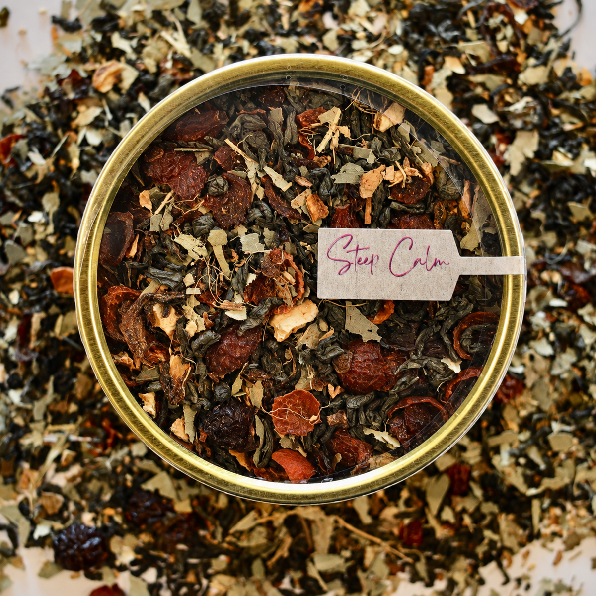 Ginger Lemon Lift top view Herbal Tea 30 cups of tea size gold finish tin sitting on loose leaf tea that contains Green tea*, rose hip*, eucalyptus*, lemon*, ginger*.