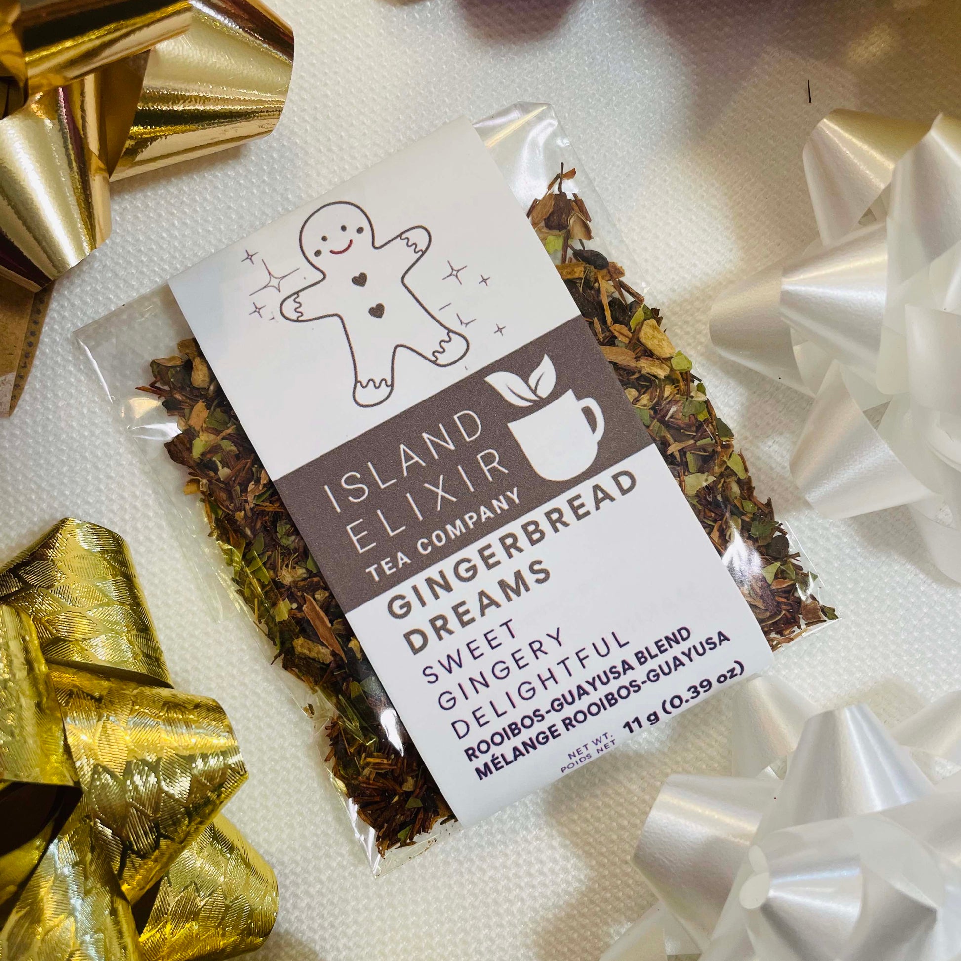 Island Elixir Gingerbread Dreams tea package with decorative bows on a white background