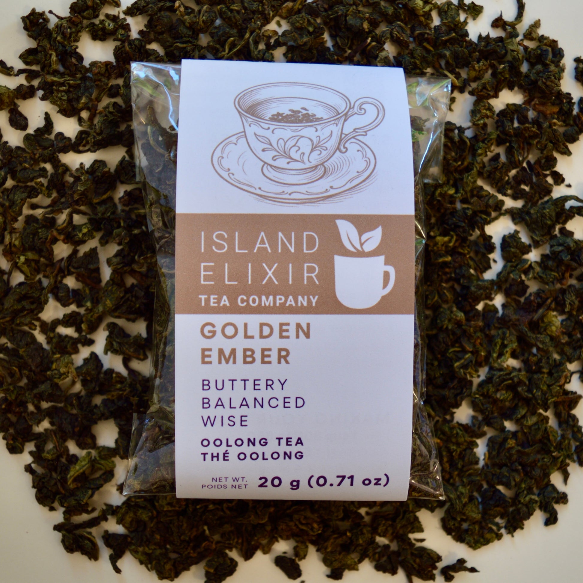 Golden Ember black Tea 10 cups of tea size compostable packaging sitting on loose leaf tea that contains Lightly oxidized oolong tea from China