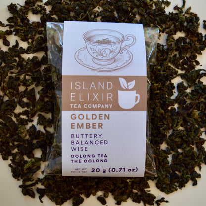 Golden Ember black Tea 10 cups of tea size compostable packaging sitting on loose leaf tea that contains Lightly oxidized oolong tea from China