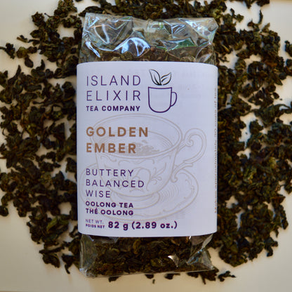 Golden Ember black Tea 30 cups of tea size compostable packaging sitting on loose leaf tea that contains Lightly oxidized oolong tea from China