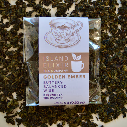 Golden Ember black Tea 4 cups of tea size compostable packaging sitting on loose leaf tea that contains Lightly oxidized oolong tea from China