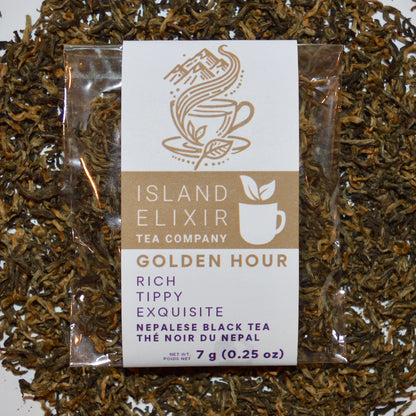 Golden hour Black Tea 4 cups of tea size compostable packaging sitting on loose leaf tea that contains Nepalese black tea (Certified organic)