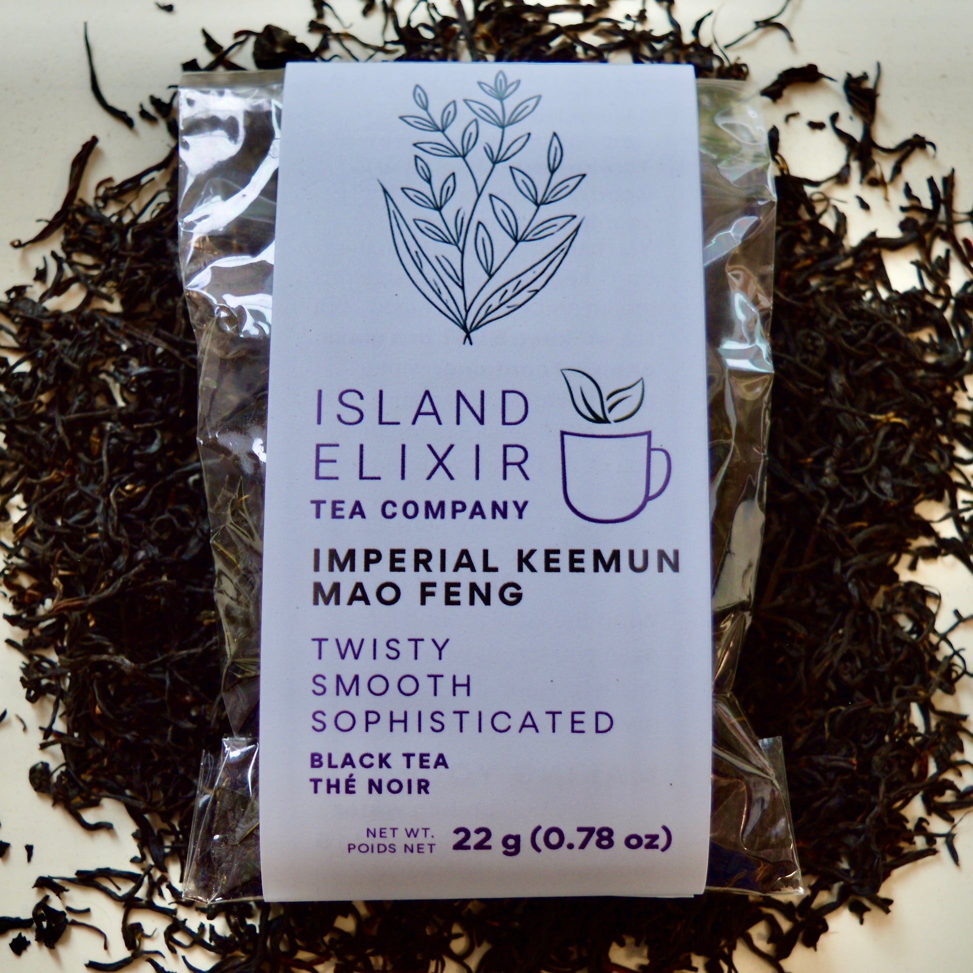 Imperial Keemun Mao Feng Black Tea 10 cups of tea size compostable packaging sitting on loose leaf tea that contains Chinese black tea (Certified organic)