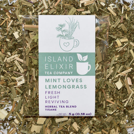 Mint loves lemongrass Herbal Tea 4 cups of tea size compostable packaging sitting on loose leaf tea that contains Lemongrass*, peppermint*, spearmint*, lemon verbena*