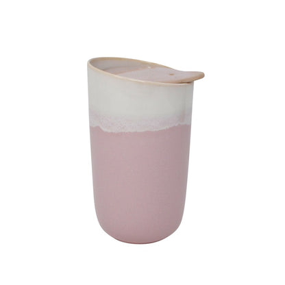 A tapered double-walled ceramic tumbler with a glossy finish, featuring a two-tone design with a white top half and a dusty pink bottom half, topped with a matching light pink lid. Holds 325 mL tea or coffee or hot chocolate or any drink. Available for purchase online or in our Langford BC tea shop.