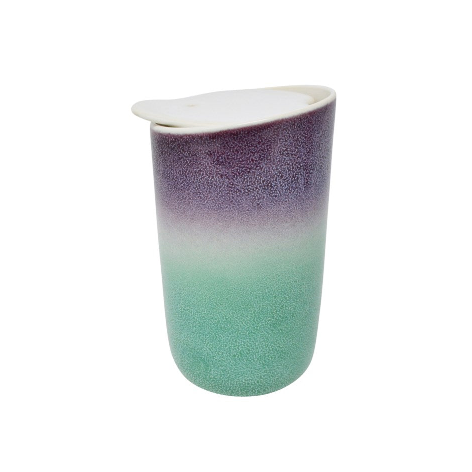 A double-walled ceramic travel tumbler with a white lid, featuring a gradient design that transitions from a textured purple at the top to a mint green at the bottom, set against a plain white background. Holds 325 mL tea or coffee or hot chocolate or any drink. Available for purchase online or in our Langford BC tea shop.
