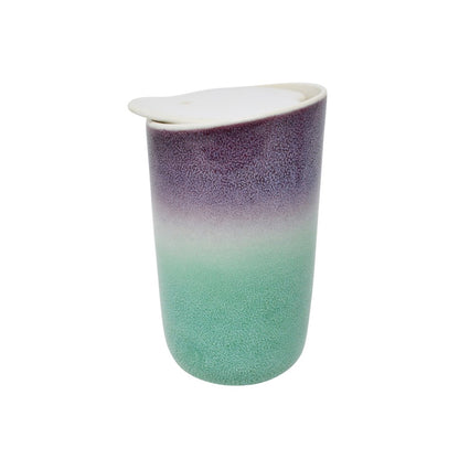 A double-walled ceramic travel tumbler with a white lid, featuring a gradient design that transitions from a textured purple at the top to a mint green at the bottom, set against a plain white background. Holds 325 mL tea or coffee or hot chocolate or any drink. Available for purchase online or in our Langford BC tea shop.
