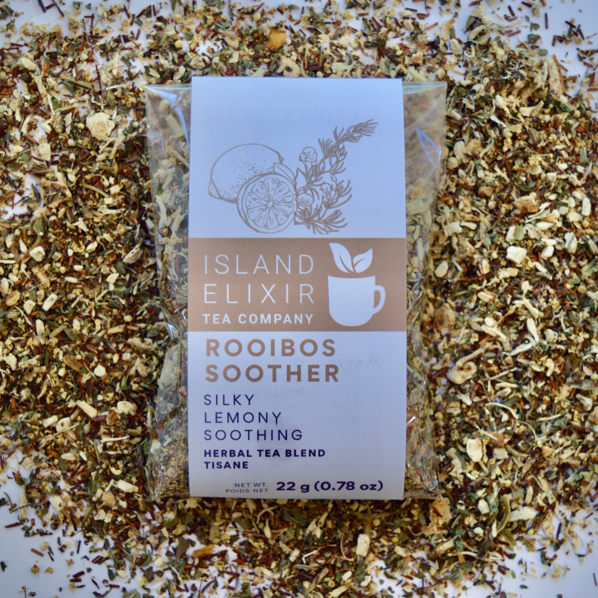 Rooibos Soother Herbal Tea 10 cups of tea size compostable packaging sitting on loose leaf tea that contains Marshmallow root, lemon, rooibos, elderflower, peppermint