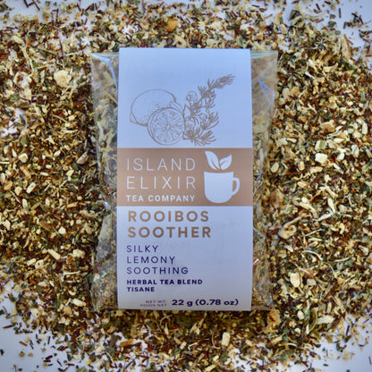Rooibos Soother Herbal Tea 10 cups of tea size compostable packaging sitting on loose leaf tea that contains Marshmallow root, lemon, rooibos, elderflower, peppermint