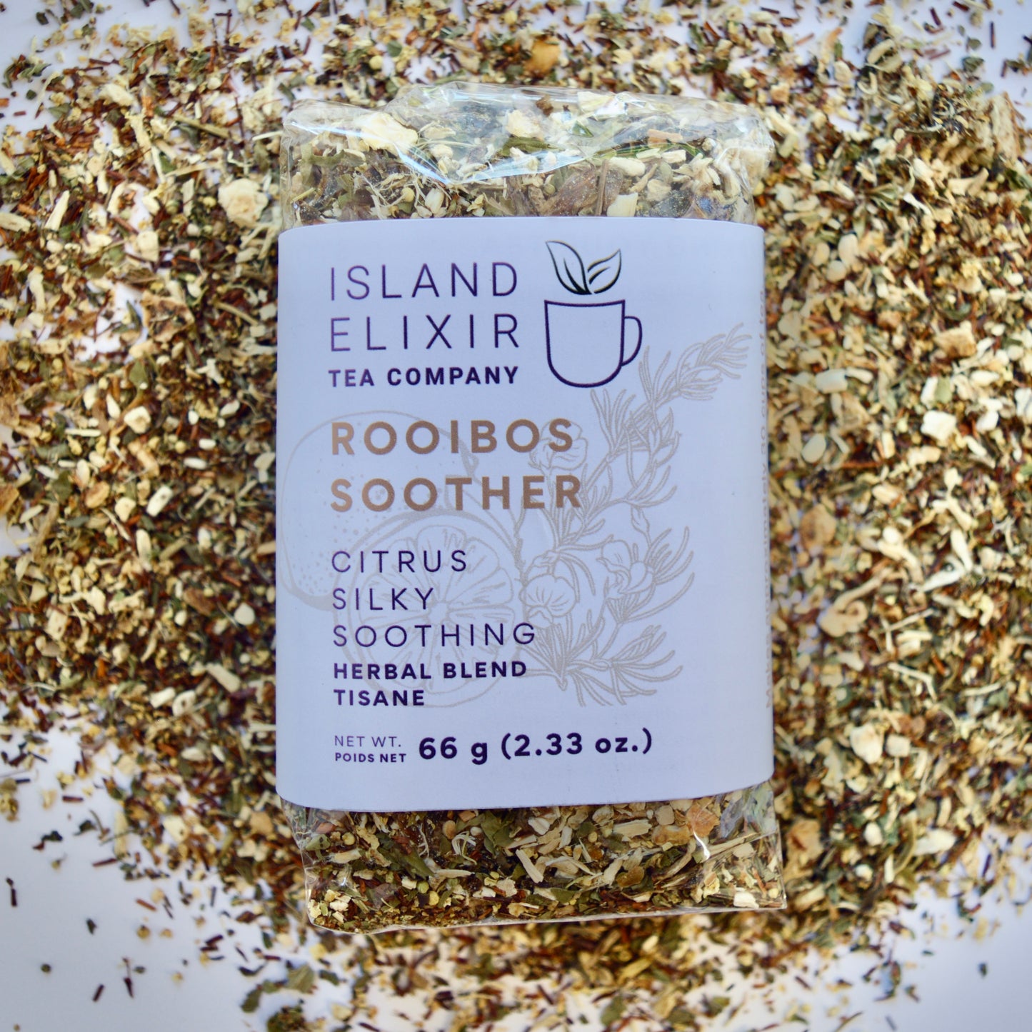 Rooibos Soother Herbal Tea 30 cups of tea size compostable packaging sitting on loose leaf tea that contains Marshmallow root, lemon, rooibos, elderflower, peppermint