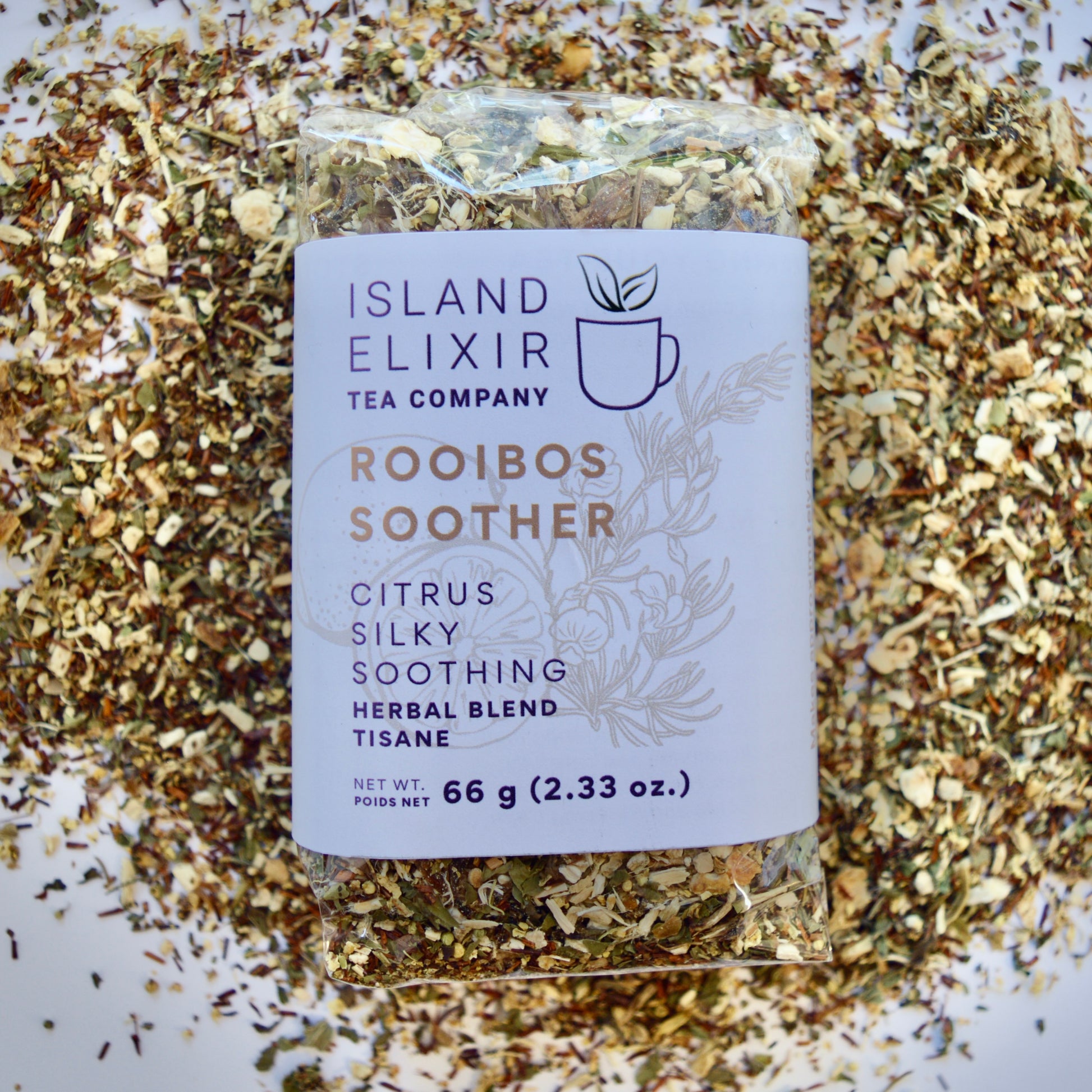 Rooibos Soother Herbal Tea 30 cups of tea size compostable packaging sitting on loose leaf tea that contains Marshmallow root, lemon, rooibos, elderflower, peppermint