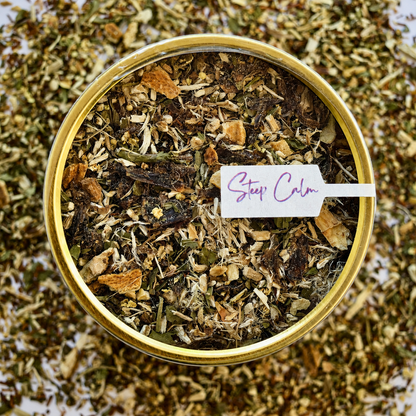 Rooibos Soother Herbal Tea top view 30 cups of tea size gold finish tin sitting on loose leaf tea that contains Marshmallow root, lemon, rooibos, elderflower, peppermint