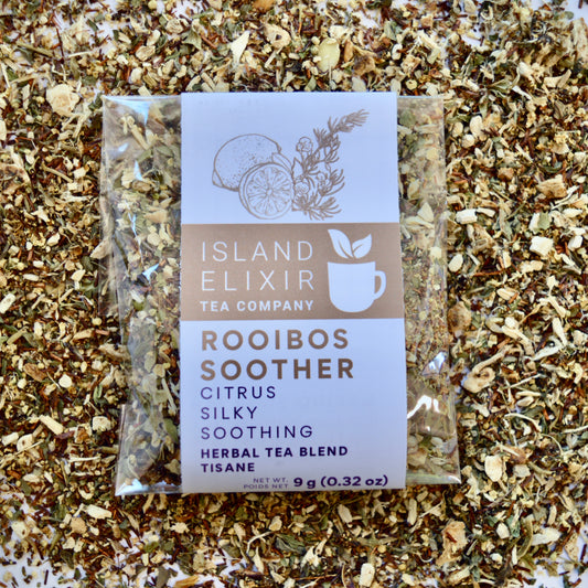 Rooibos Soother Herbal Tea 4 cups of tea size compostable packaging sitting on loose leaf tea that contains Marshmallow root, lemon, rooibos, elderflower, peppermint