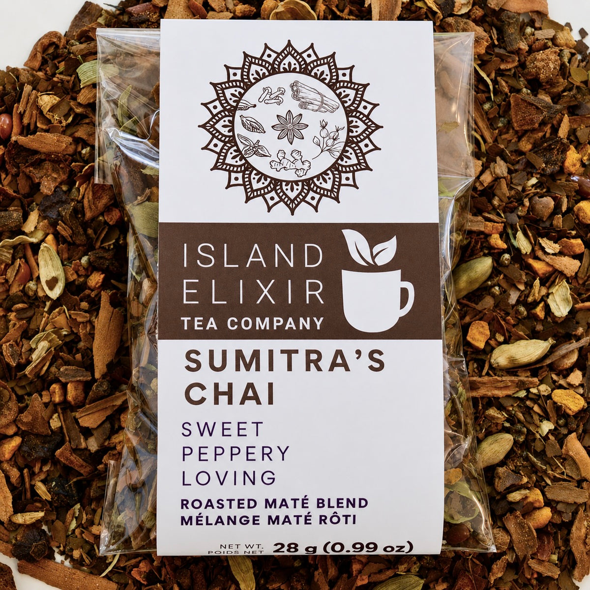 Sumitra's Chai Herbal Tea 10 cups of tea size compostable packaging sitting on loose leaf tea that contains Cinnamon*, Cardamom*, Rose hip*, Star anise*, Turmeric*, Roasted maté*, Clove*, Ginger*.