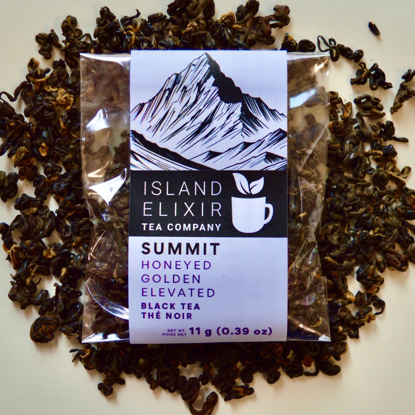 Summit Black Tea 4 cups of tea size compostable packaging sitting on loose leaf tea that contains Nepalese black tea