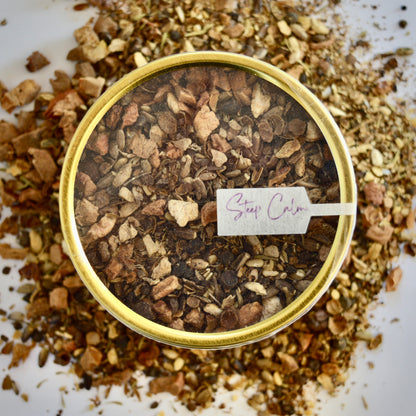 Tea Thyme Herbal Tea 30 cups of tea size gold finish tin sitting on loose leaf tea that contains Allspice, milk thistle seed, apple, ginger, grapefruit, thyme.
