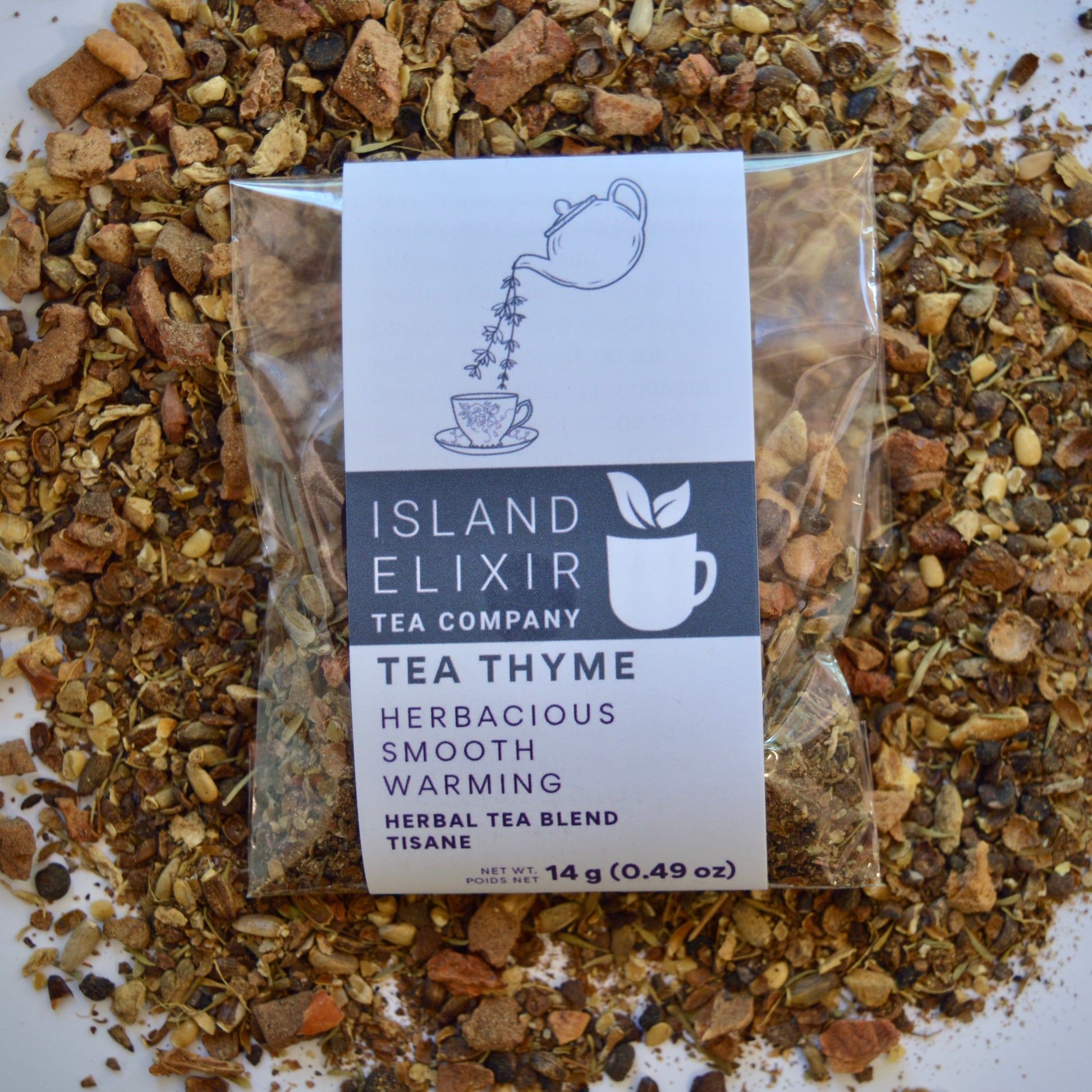 Tea Thyme Herbal Tea 4 cups of tea size compostable packaging sitting on loose leaf tea that contains Allspice, milk thistle seed, apple, ginger, grapefruit, thyme.