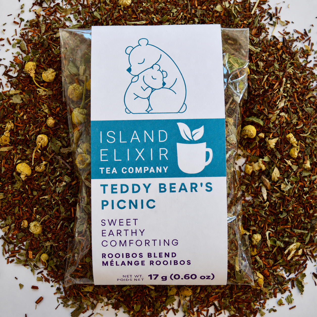 Teddy bear Picnic Herbal Tea 10 cups of tea size compostable packaging sitting on loose leaf tea that contains Rooibos, lemon balm, peppermint, chamomile