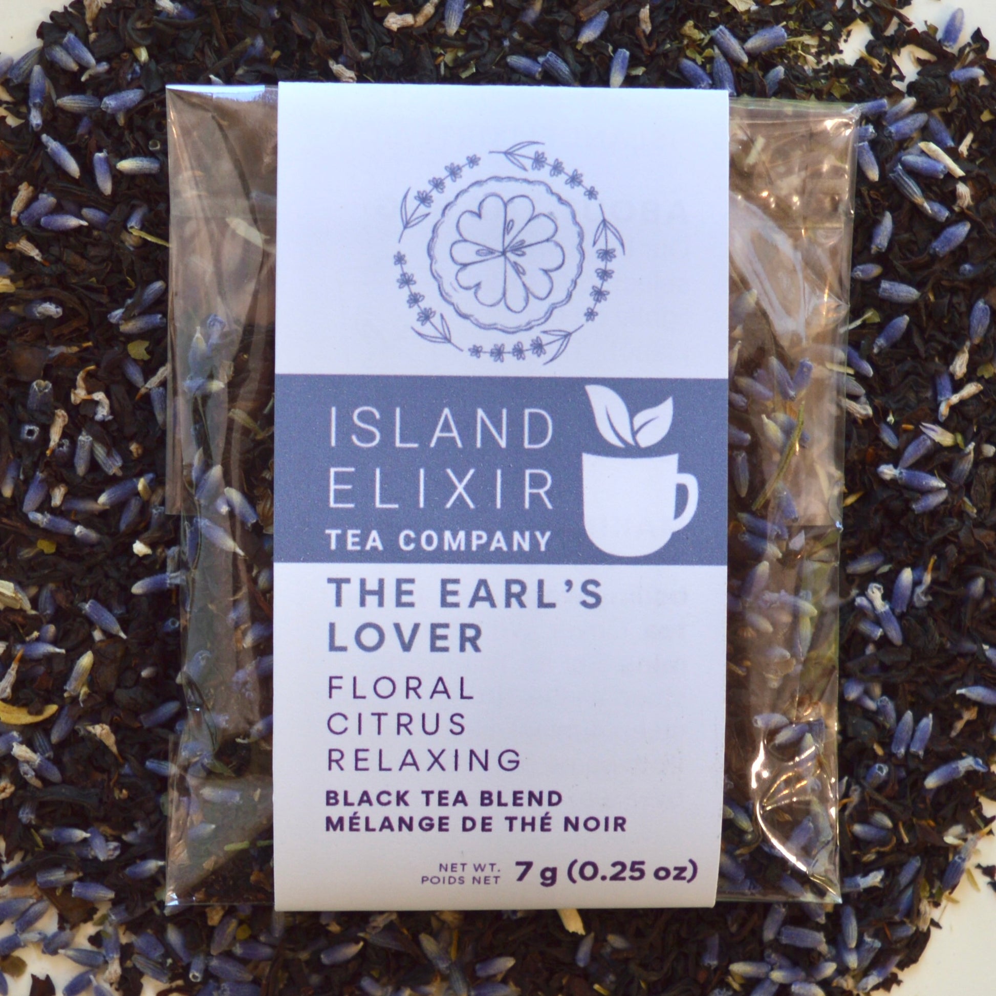 The Earl's Lover Black Tea 4 cups of tea size compostable packaging sitting on loose leaf tea that contains Black tea*, lavender**, anise hyssop*, bergamot flavour (organic compliant) 
