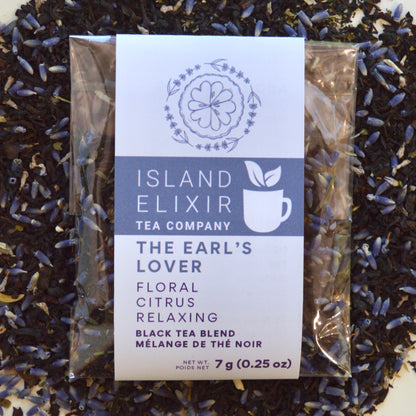 The Earl's Lover Black Tea 4 cups of tea size compostable packaging sitting on loose leaf tea that contains Black tea*, lavender**, anise hyssop*, bergamot flavour (organic compliant) 
