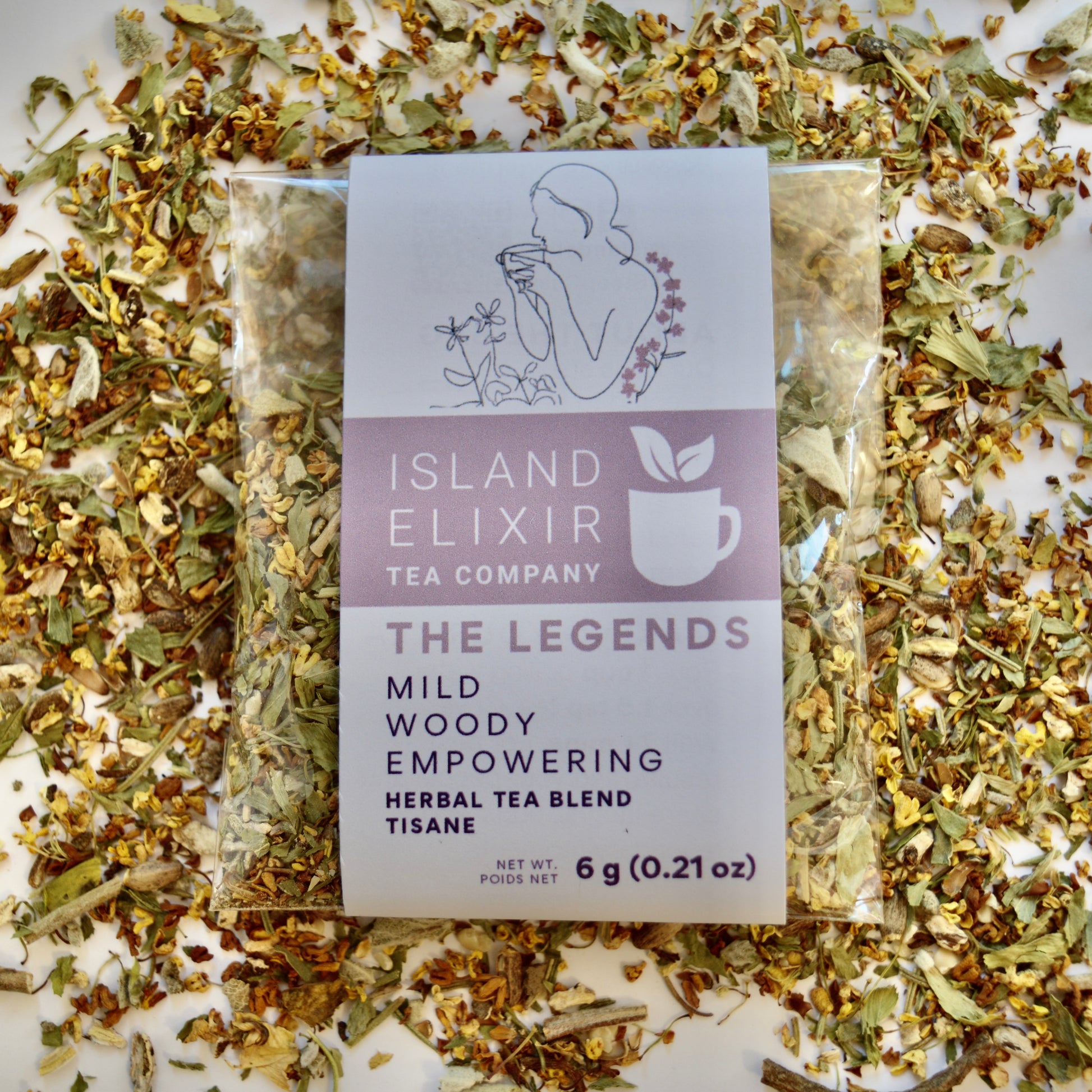 The Legends Herbal Tea 4 cups of tea size compostable packaging, sitting on loose tea that contains Milk thistle seed, Osmanthus, Dandelion root, Alfalfa, Sage, Rosemary.