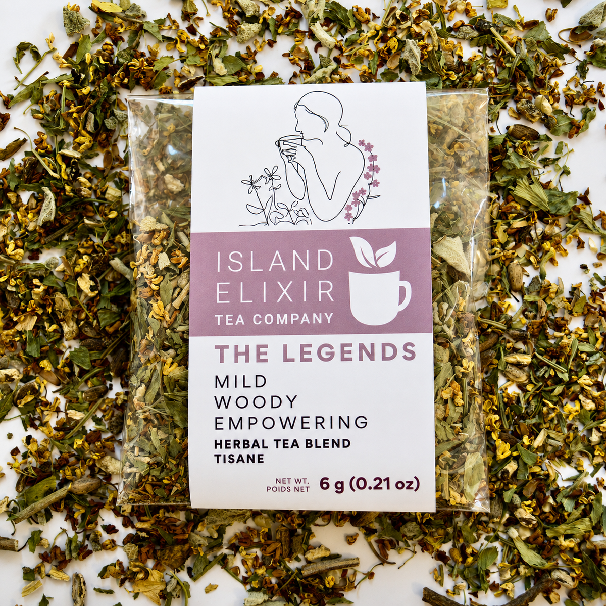 The Legends Herbal Tea 4 cups of tea size compostable packaging, sitting on loose tea that contains Milk thistle seed, Osmanthus, Dandelion root, Alfalfa, Sage, Rosemary.