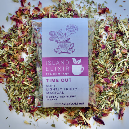 Time out Herbal Tea 10 cups of tea size compostable packaging sitting on loose leaf tea that contains Raspberry, Alfalfa, Oatstraw, Rose, Rooibos, Nettle, Red clover, Raspberry leaf