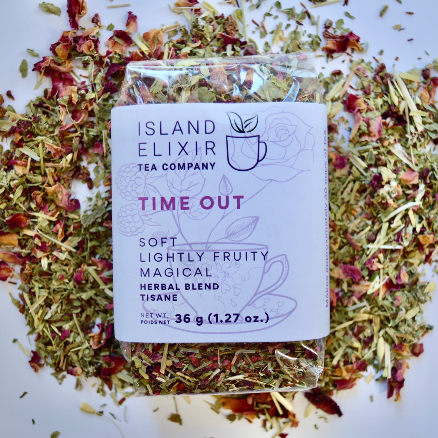Time out Herbal Tea 30 cups of tea size compostable packaging sitting on loose leaf tea that contains Raspberry, Alfalfa, Oatstraw, Rose, Rooibos, Nettle, Red clover, Raspberry leaf