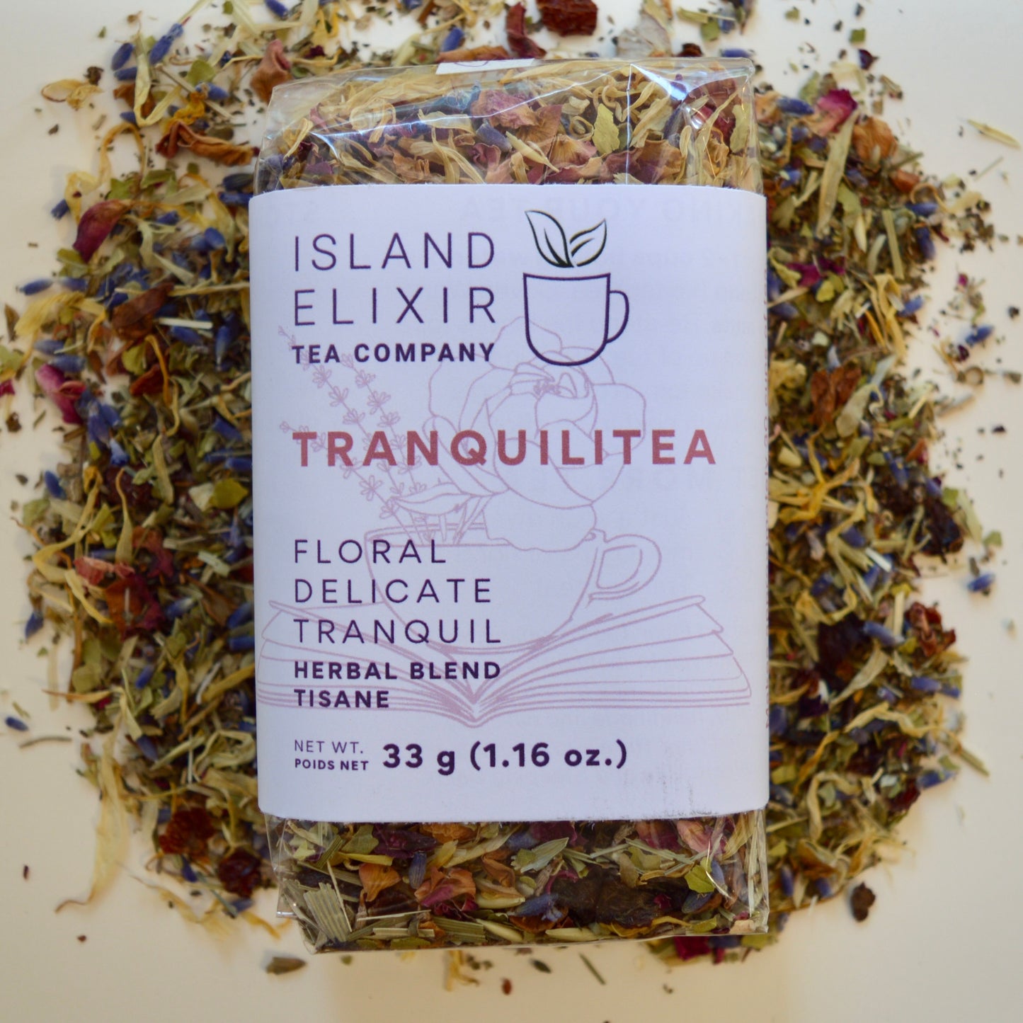 Tranquilitea Herbal Tea 30 cups of tea size compostable packaging sitting on loose leaf tea that contains Rose hip*, Lemon balm*, Lavender**, Oatstraw*, Marshmallow leaf*, Calendula*, Rose petals*. 