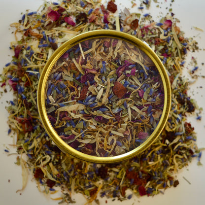 Tranquilitea Herbal Tea 30 cups of tea size gold finish tin on loose tea that contains Rose hip*, Lemon balm*, Lavender**, Oatstraw*, Marshmallow leaf*, Calendula*, Rose petals*. 