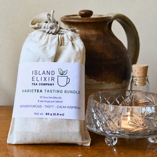 Varietea tasting bundle bag with candle and tea pot behind it.