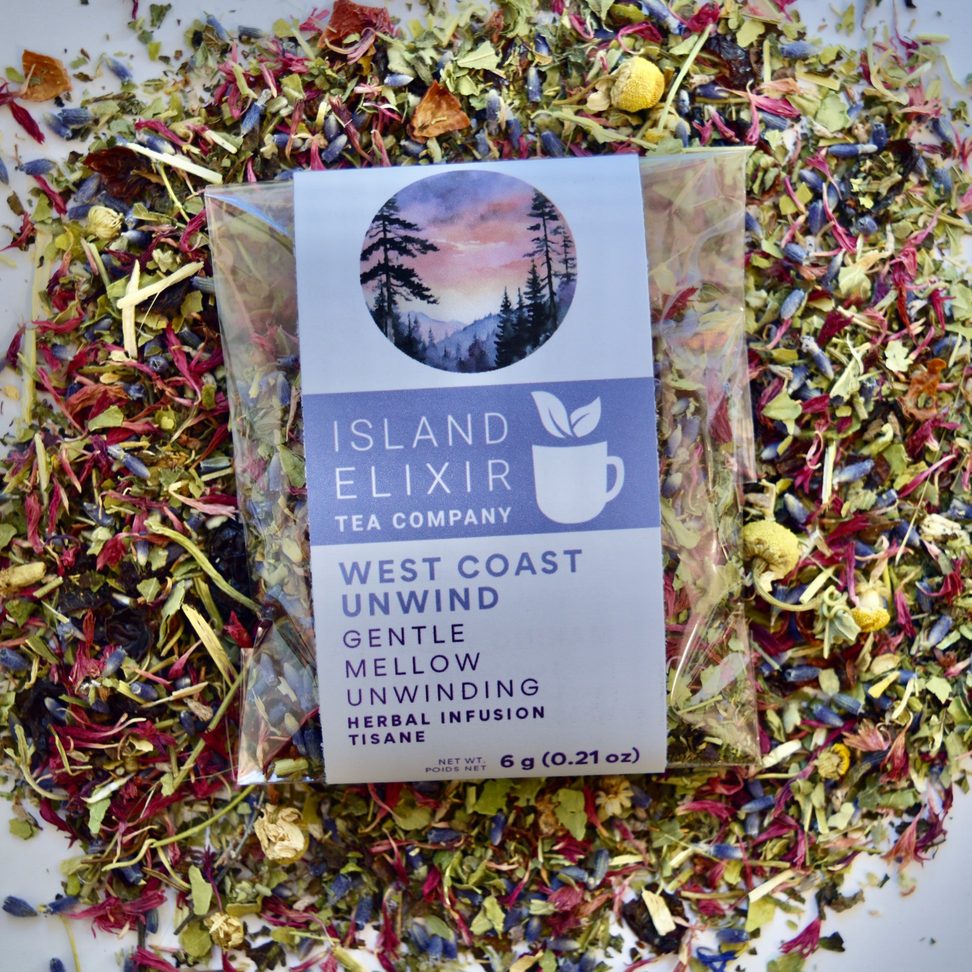West Coast Unwind Herbal Tea 4 cups of tea size compostable packaging sitting on loose leaf tea that contains rose hip, lemon balm, lavender, marshmallow leaf, passion flower chamomile, red cornflower.